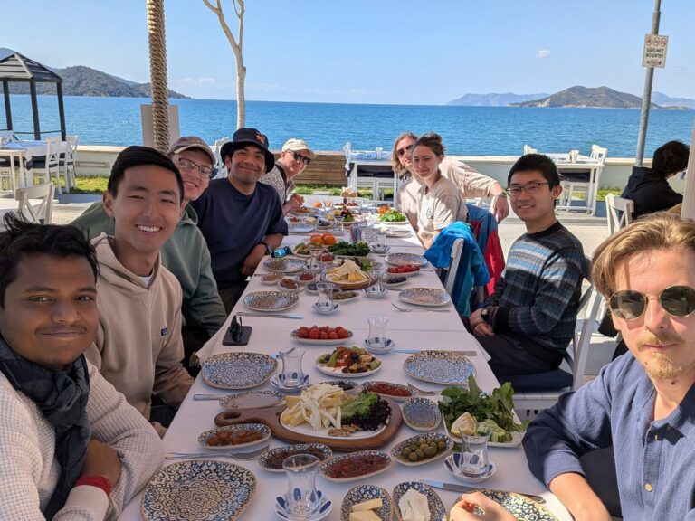 Members of the Rao Group at breakfast by the sea during the 2026 group retreat